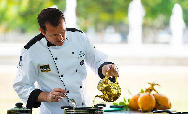 A Chef is adding Tea into The Dish